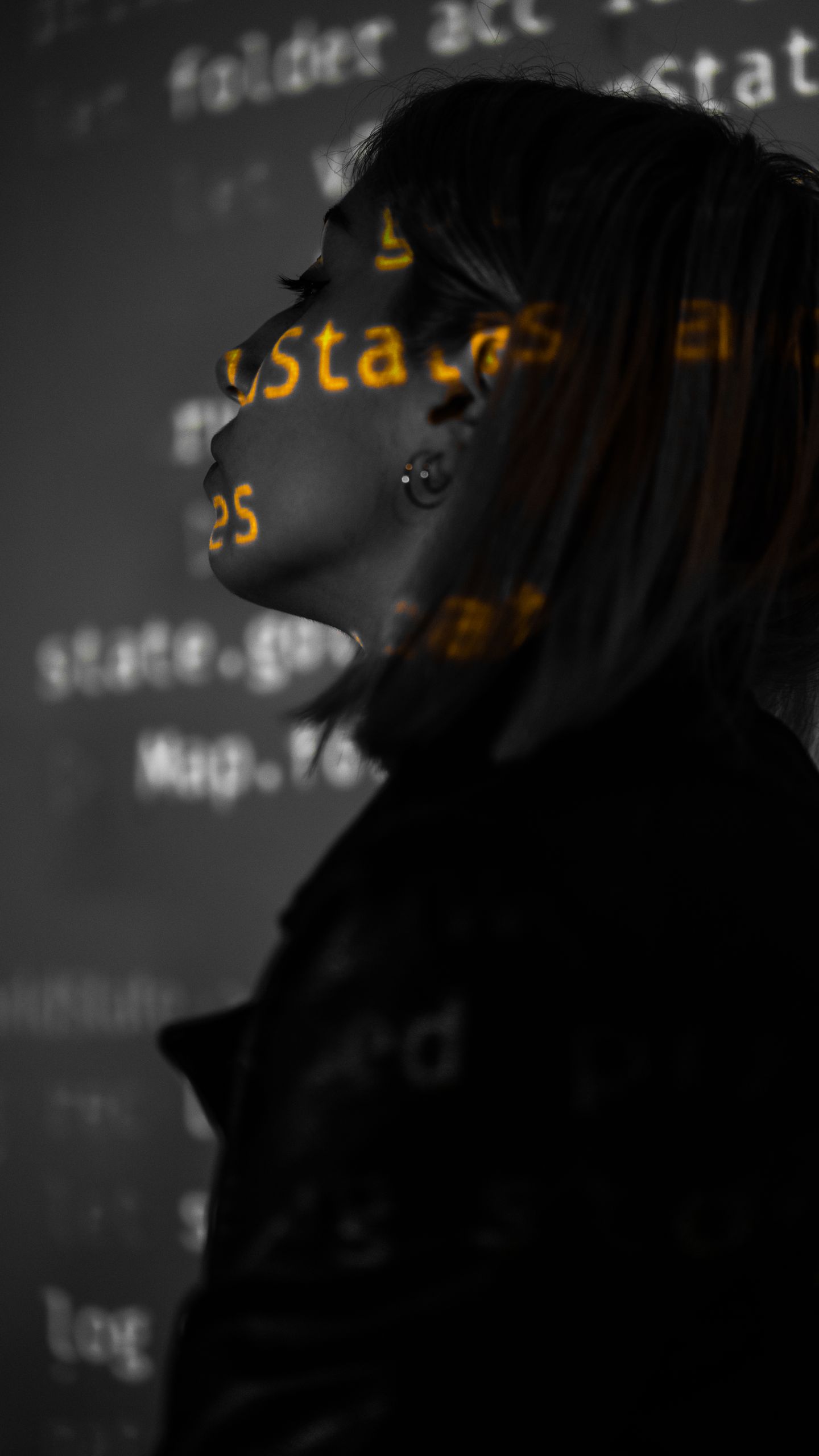 Silhouette profile of woman with digital code projection on face, blending technology and art.